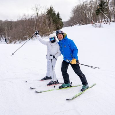 A ski instructor and student pose for a picture after a successful lesson!